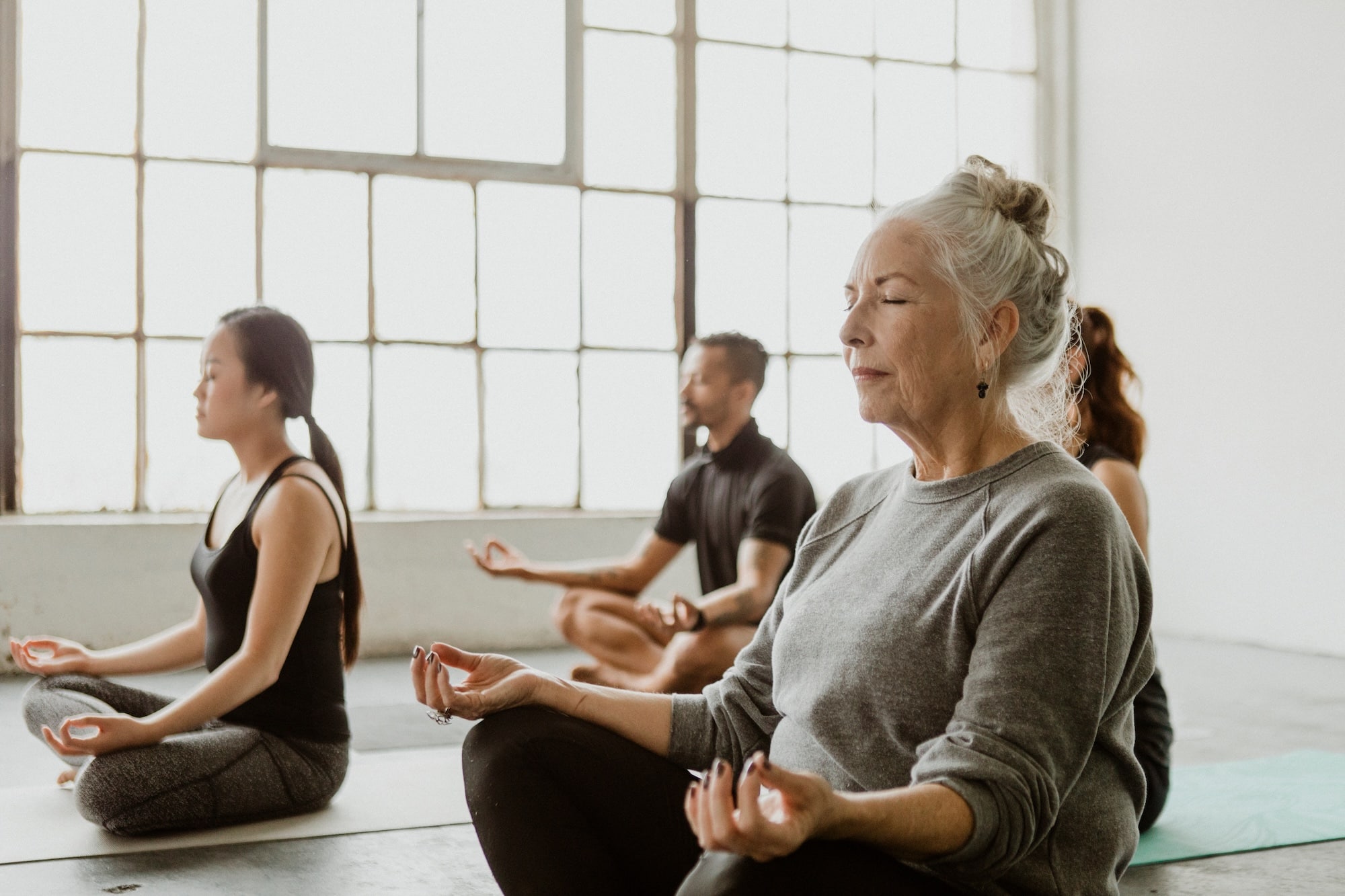A group of people meditating in a room.